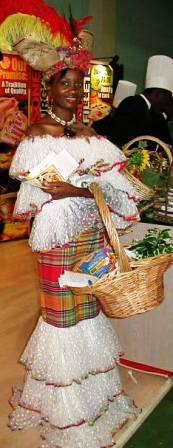 Woman wearing fancy Caribbean costume and carrying a market basket full of Caribbean food.  Jamaican food.